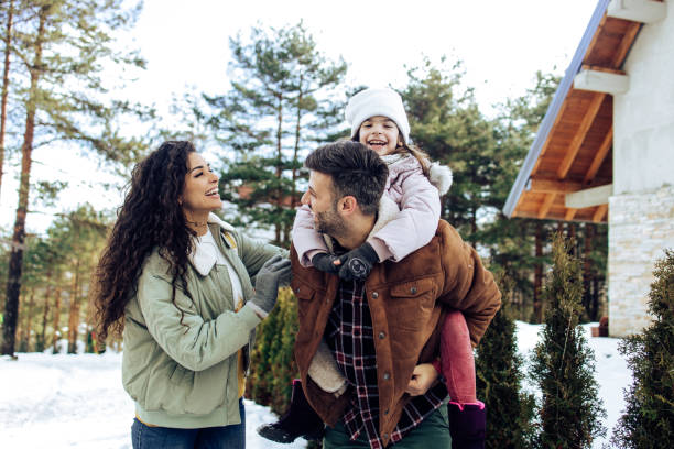 famille heureuse ayant l’amusement pendant leurs vacances d’hiver - nature forest clothing smiling photos et images de collection