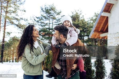 istock Happy family having fun during their winter vacation 1307650021