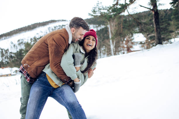 istock Playful couple enjoying on the snow 1307650108