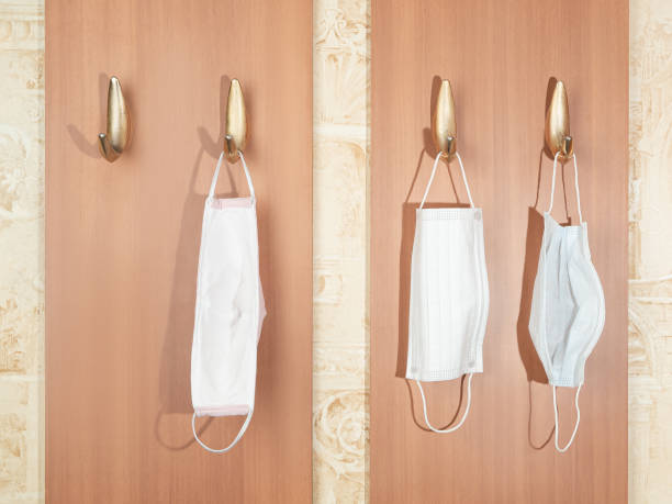 istock three different protective masks from coronavirus hang on hooks in the hallway 1307650227