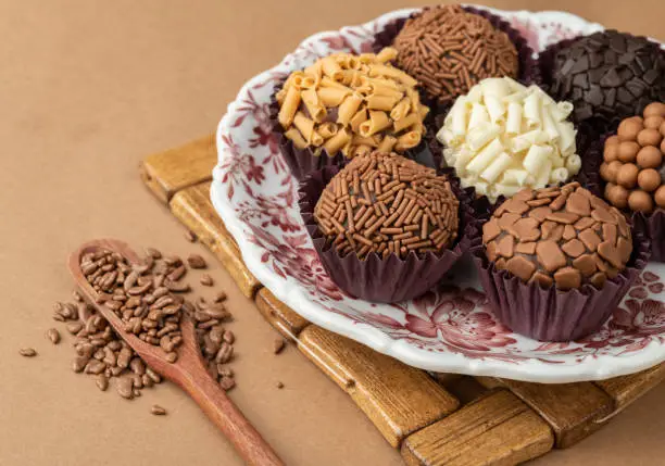 Typical brazilian brigadeiros on a plate with chocolate sprinkles.