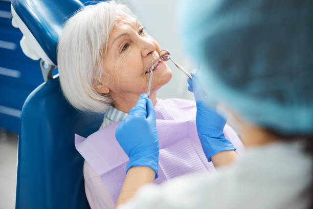 istock Old person having her teeth checked during dental examination 1307652127