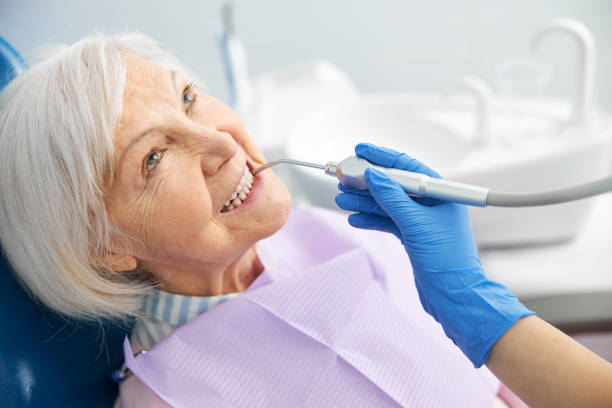 istock Dental specialist using air water spray handpiece 1307652130