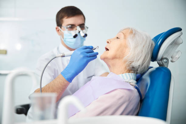 istock Man dental specialist working on aging female teeth 1307652167