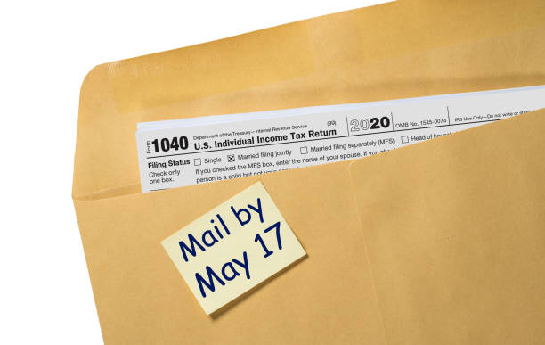 istock Tax Day reminder for May 17 on envelope for filing returns for 2020 1307653218