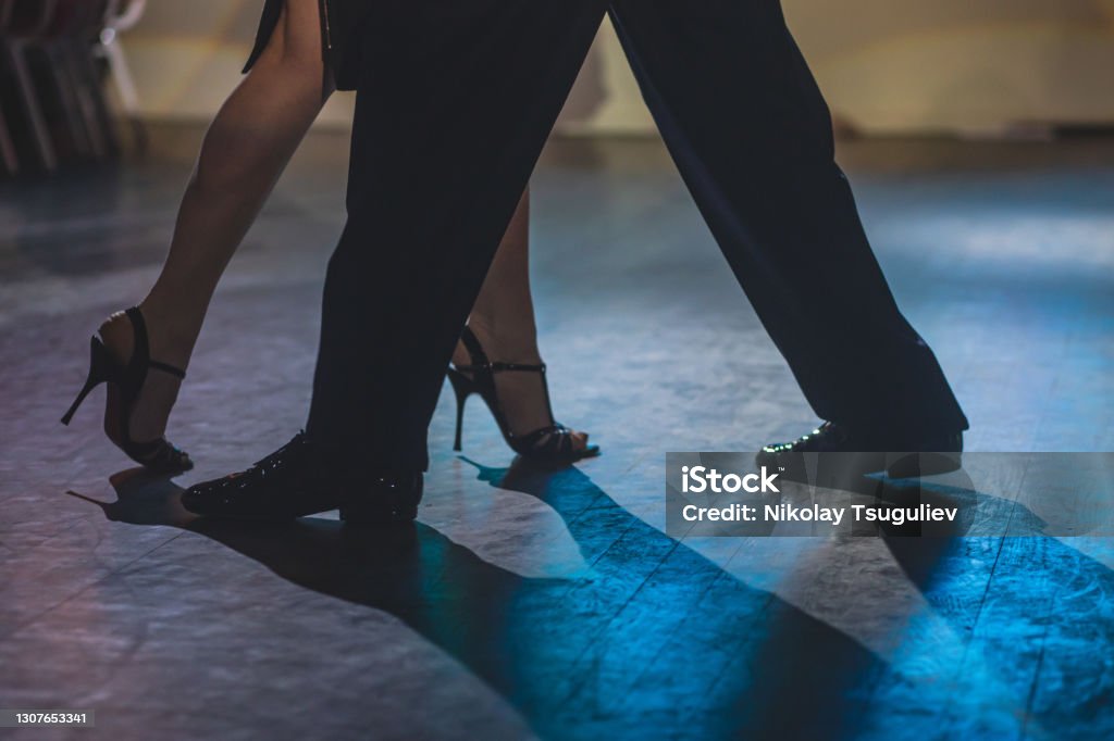 Dancing shoes of young couple, Couples dancing traditional latin argentinian dance milonga in the ballroom, tango salsa bachata kizomba lesson, dance festival, wooden floor, close up view of shoes Dancing shoes of young couple, Couples dancing traditional latin argentinian dance milonga in the ballroom, tango salsa bachata kizomba lesson, dance festival, wooden floor, close view of shoes Dancing Stock Photo