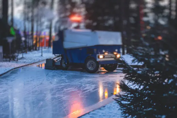 An ice resurfacing machine, ice resurfacer on a ice rink, resurfacing and maintenance of the ice rink with a new year decoration and illumination