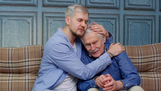 istock Young man asking for apologizes to offended stressed elderly senior father sitting together on couch 1307655282