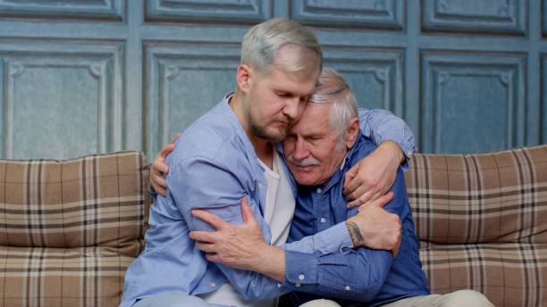 Adult man son hugging and consoling sadness old age father with love, mental health, social problems Handsome adult Caucasian man comforting his depressed senior father, asking about problems. Son hugging, consoling sadness old age dad with love. Mental health, healthcare and social problems concept mercy hug stock pictures, royalty-free photos & images