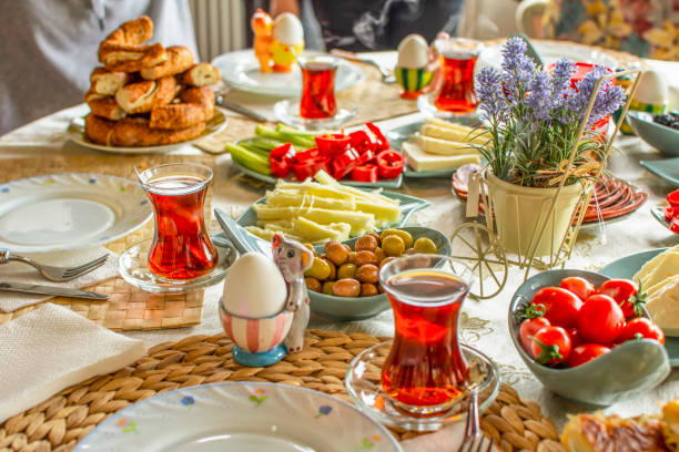 istock Delicious rich Traditional Turkish breakfast include tomatoes, cucumbers, cheese, butter, eggs, honey, bread, bagels, olives and tea cups. Ramadan Suhoor aka Sahur. 1307655570