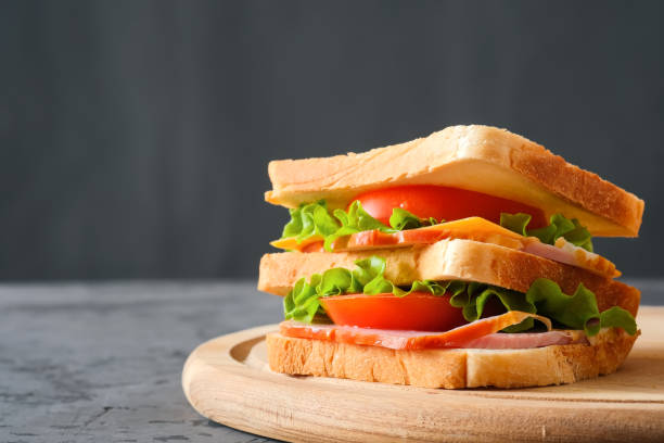 istock Big tasty sandwich on gray background 1307656279