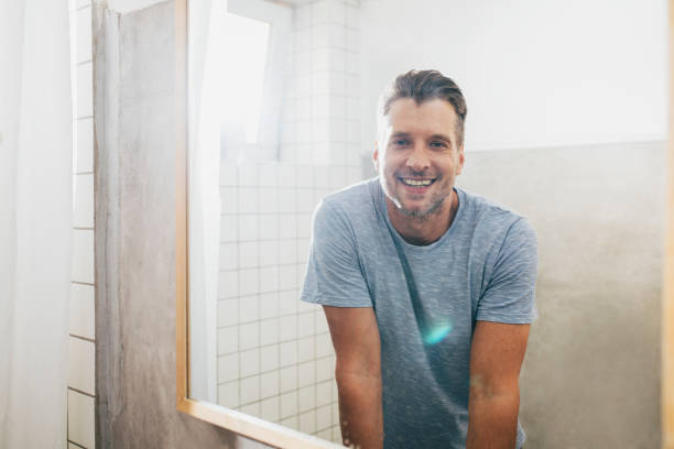 istock Handsome Young Man Checking his Beard in a Bathroom Mirror 1307656372