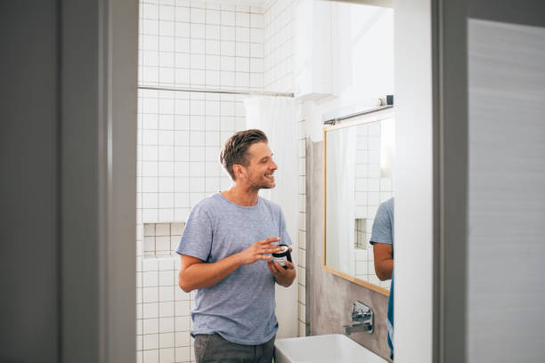 istock Handsome Young Man Applying Face Cream after a Morning Shave 1307656378