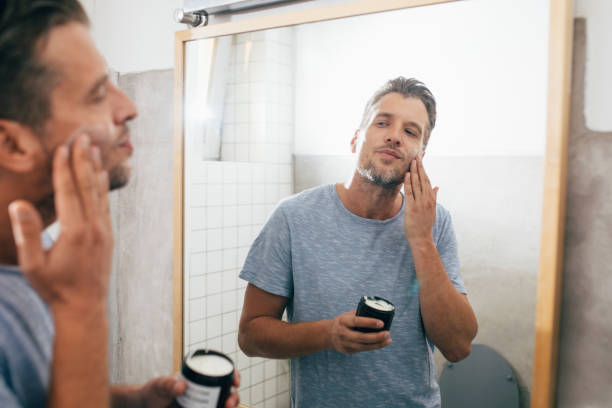 istock Handsome Young Man Applying Face Cream after a Morning Shave 1307656387