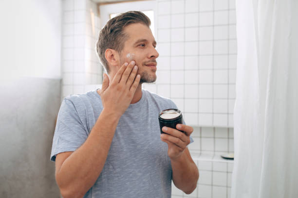 istock Handsome Young Man Applying Face Cream after a Morning Shave 1307656390