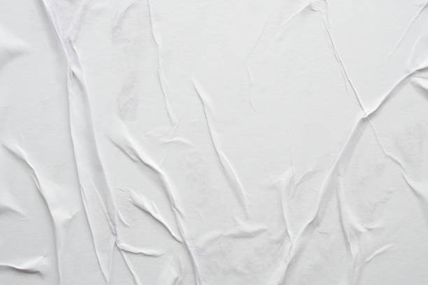 istock Blank white crumpled and creased paper poster texture background 1307657311