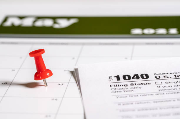 istock Tax Day concept for May 17 2021 using calendar and push pin 1307662655