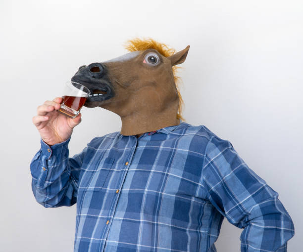 istock man in a horse mask. horsey drinks cognac. 1307662929