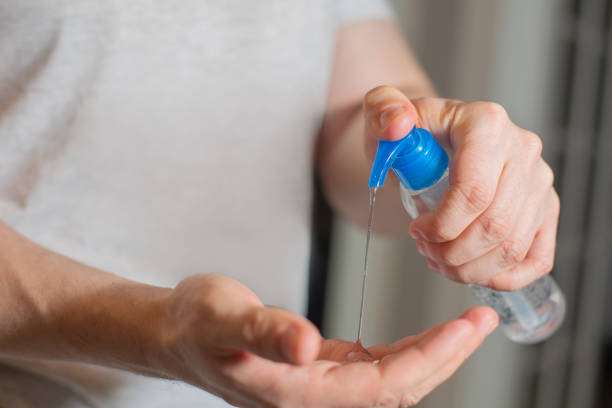 istock Man using antiseptic gel and cleans his hands 1307664104
