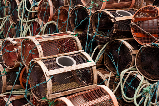 Rows of crab pots or lobster traps at the dock in fishermen village Poio in Galicia, Spain