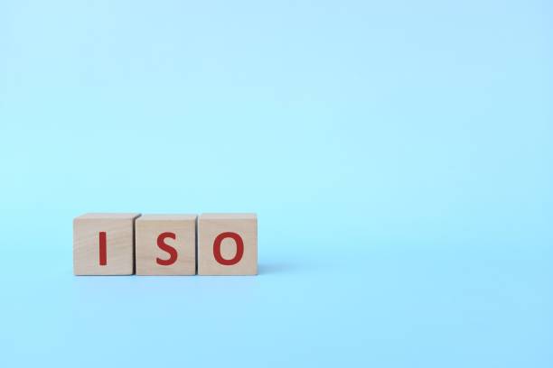 istock ISO acronym or International Organization for Standardization on wooden blocks in blue background with copy space. 1307665838