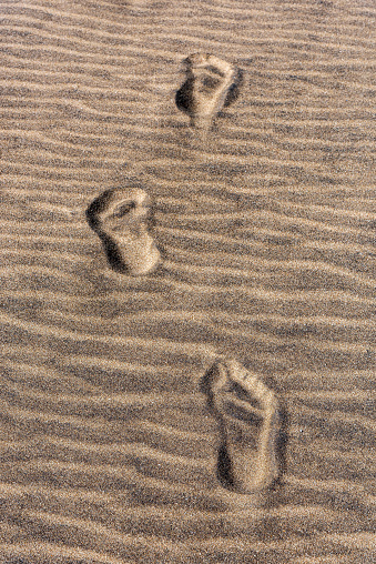 Footprints on yellow sand at the seaside in Turkey.