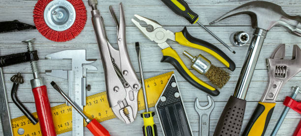 istock set of renovation and working tools on DIY table background including vernier caliper, wrenches, hammer, pliers 1307677546