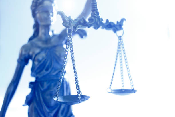 istock Lady Justice In Front Of Bright Background 1307679844