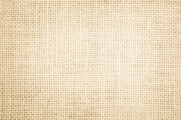 istock Jute hessian sackcloth canvas woven texture pattern background in light beige cream brown color blank empty 1307679863