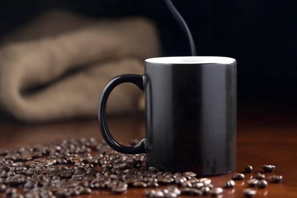 istock Steaming cup of coffee and coffee beans. 1307683175
