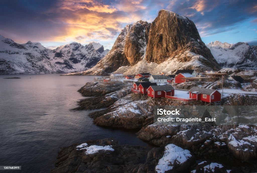 Evening view of famous tourist attraction Hamnoy fishing village on Lofoten Islands, Norway with red rorbu houses in winter Norway Stock Photo