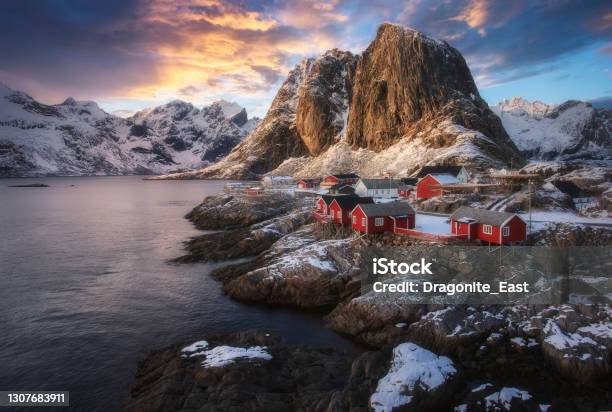 Evening View Of Famous Tourist Attraction Hamnoy Fishing Village On Lofoten Islands Norway With Red Rorbu Houses In Winter Stock Photo - Download Image Now