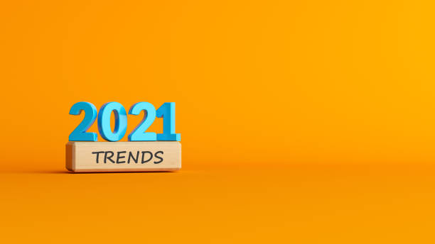 istock Trends concept Blue-colored 2021 text and woodblocks  with trends text On yellow-colored background 1307685270