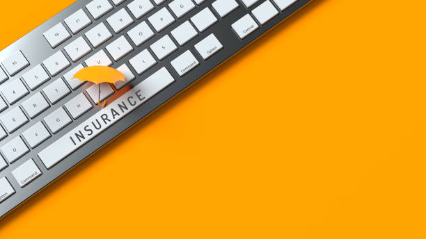 istock Insurance concept Insurance text and a yellow-colored tiny umbrella On the computer keyboard 1307685365