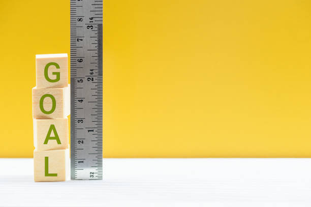 istock Word GOAL on wood cubes, measured by a ruler 1307686115