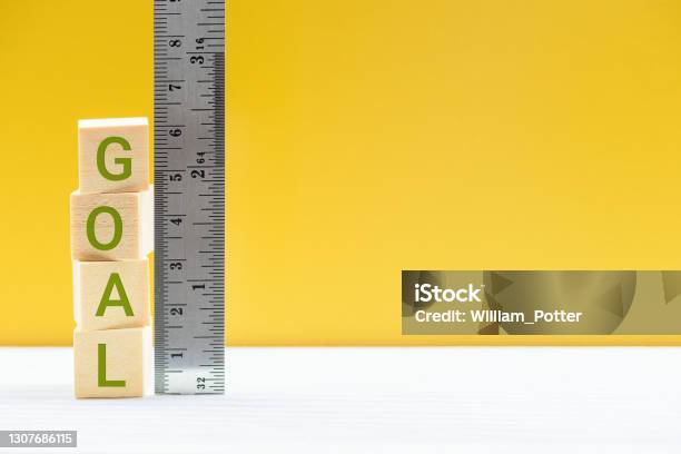Word Goal On Wood Cubes Measured By A Ruler Stock Photo - Download Image Now - Measuring, Business Strategy, Impact