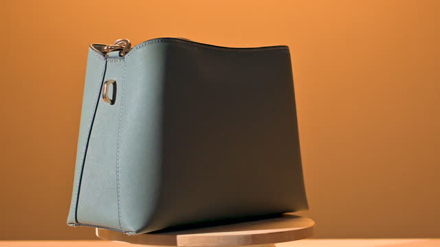 Women leather grey handbag on yellow wooden table. fashion women bag. luxury fashion women bag