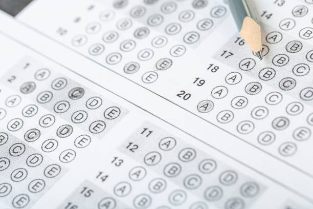 istock testing in exercise and exam paper. computer sheet with pencil in school test room, education concept 1307692548