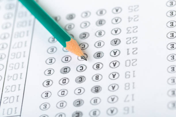 istock testing in exercise and exam paper. computer sheet with pencil in school test room, education concept 1307692582