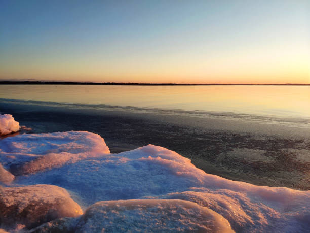 istock ice winter sunset over open water 1307695682