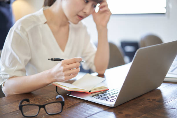 Asian women suffering from deadlines for computer work Asian women suffering from deadlines for computer work common room stock pictures, royalty-free photos & images