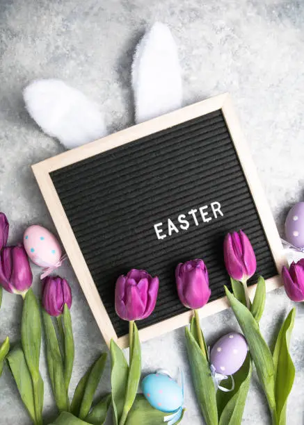 Beautiful purple  tulips on light background flat lay. Spring concept and Happy Easter greeting card, gift, poster, web concept.