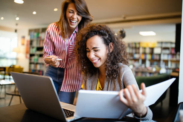istock Group of college students studying in the school library. 1307699583