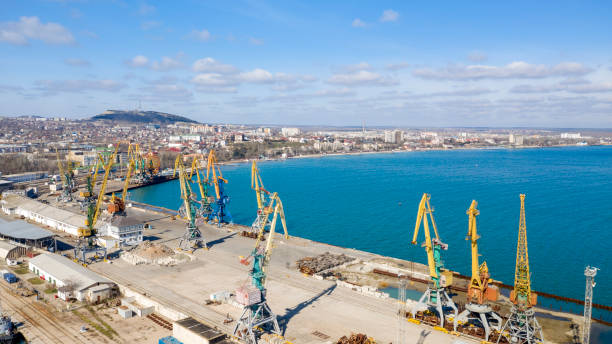 Embankment In The City Of Feodosiya from the air, seaport with high rise cranes Embankment In The City Of Feodosiya from the air, seaport with high rise cranes feodosiya stock pictures, royalty-free photos & images
