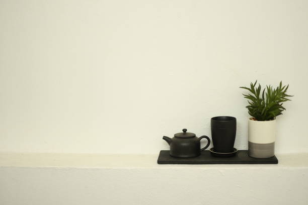 istock teapot and cup of tea on white wall beautiful relax background 1307700971