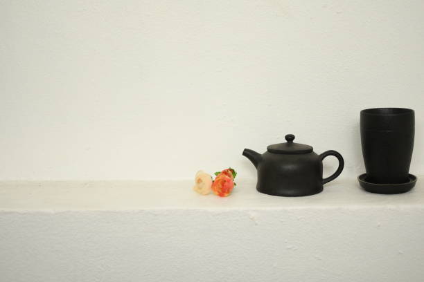 istock teapot and cup of tea on white wall beautiful relax background 1307701103
