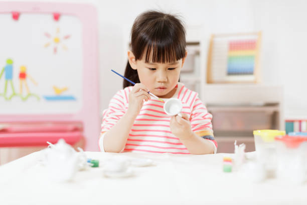 istock Young Girl Decorating Hand Made Craft For Homeschooling 1307702361