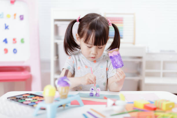 istock Young Girl Decorating Hand Made Craft For Homeschooling 1307702367