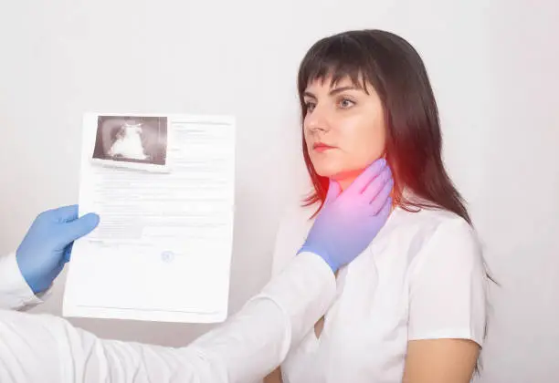 The doctor holds the results of an ultrasound examination of the throat against the background of a female patient who has a pain and a lump in her throat. Neurological and Thyroid Disease Concept