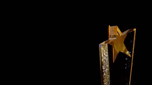 turning star shape  trophy on the black background